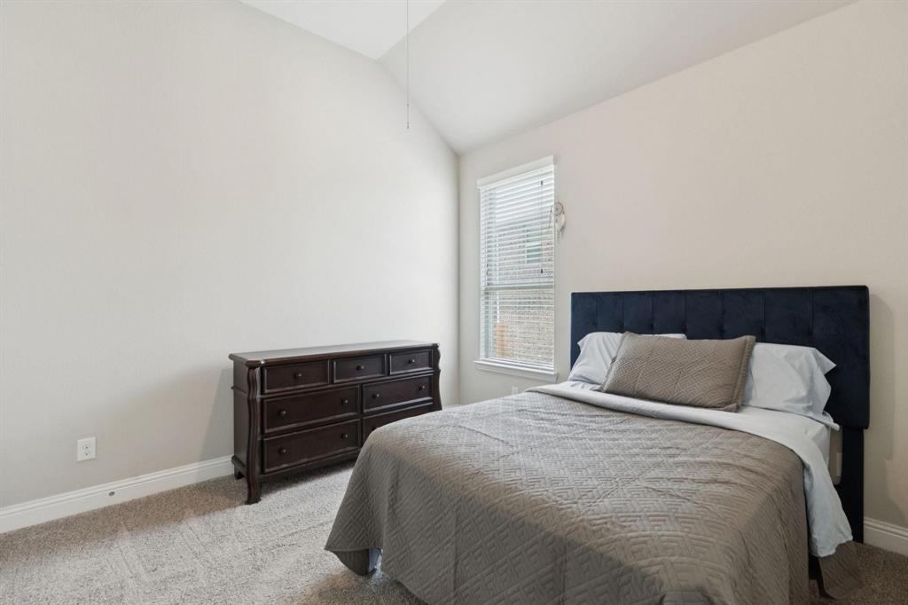 2121 Demarsh Lane Corinth, TX 76210 - Photo 29 of 39 a bedroom with a bed and a dresser