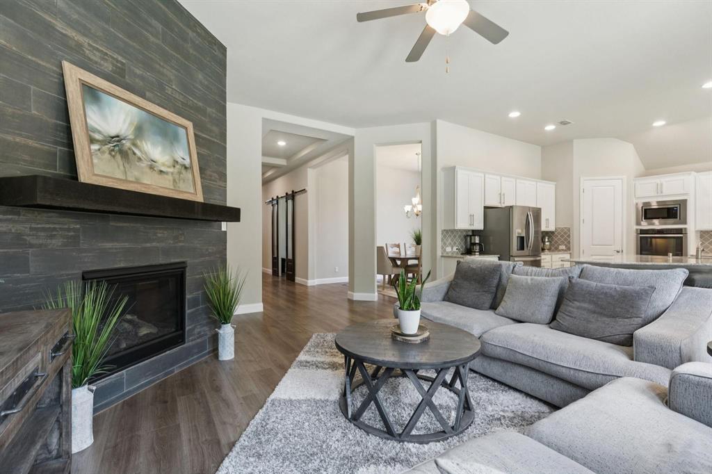 2121 Demarsh Lane Corinth, TX 76210 - Photo 9 of 39 a living room with furniture and a fireplace