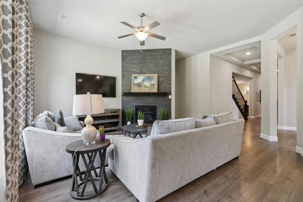 2121 Demarsh Lane Corinth, TX 76210 - Photo 10 of 39 a living room with furniture and a fireplace