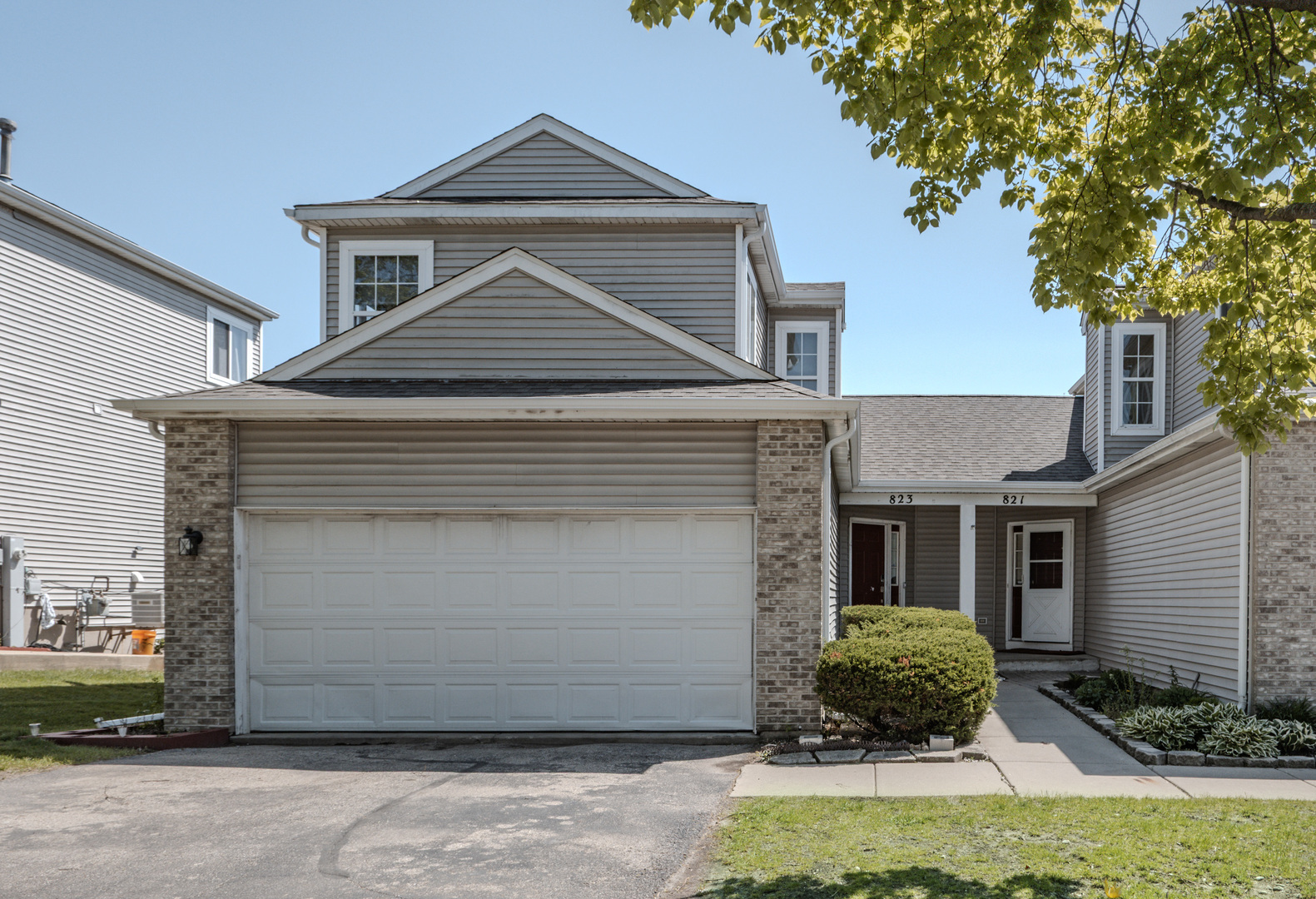823 Park Bluff Circle Elgin, IL 60120 - Photo 1 of 20 a front view of a house with a yard and garage