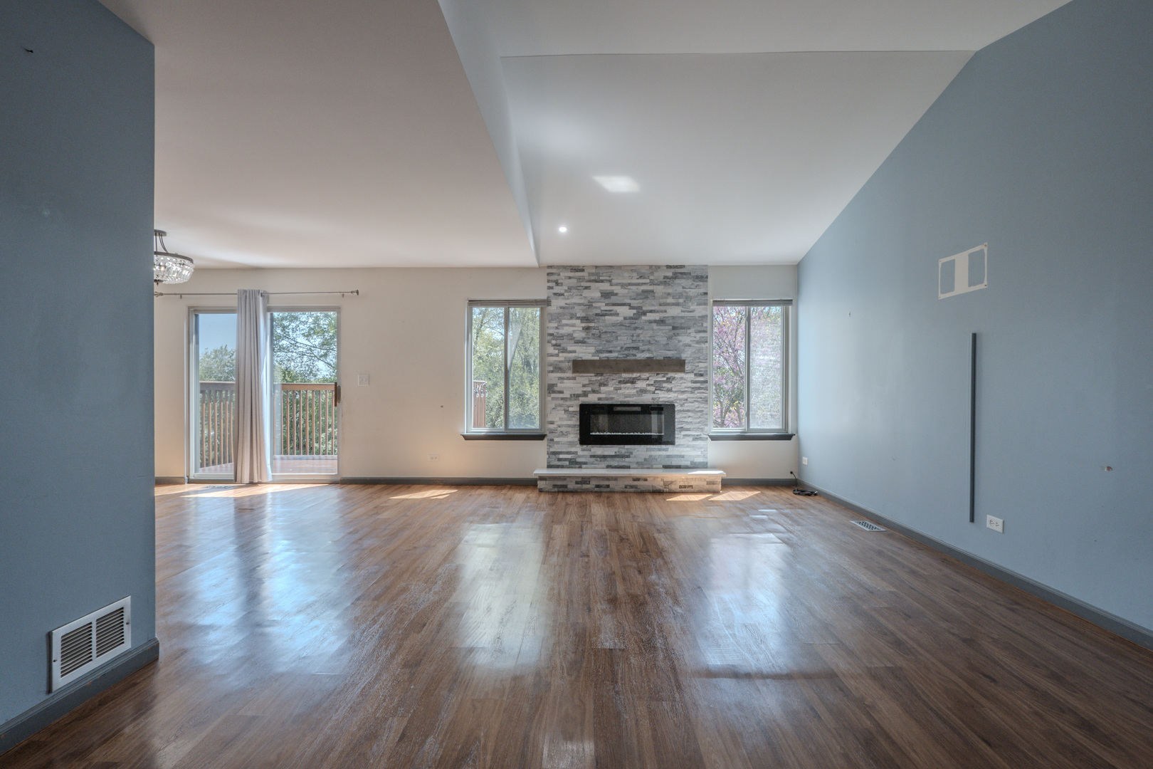 823 Park Bluff Circle Elgin, IL 60120 - Photo 5 of 20 an empty room with wooden floor fireplace and windows