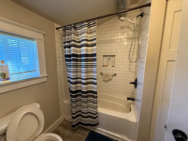 a bathroom with a shower toilet and sink