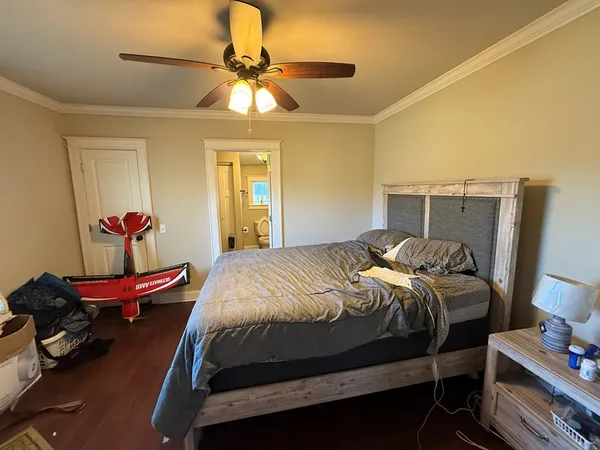a bedroom with a bed and a chandelier