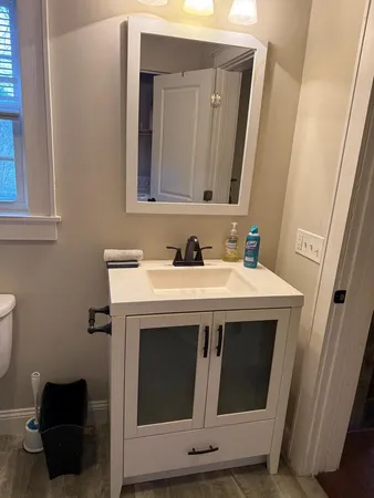 a view of storage and utility room with wooden floor