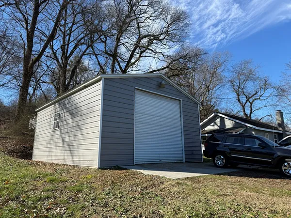 a view of house with a yard