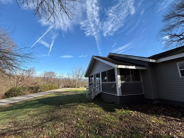 a view of house with backyard space and garden