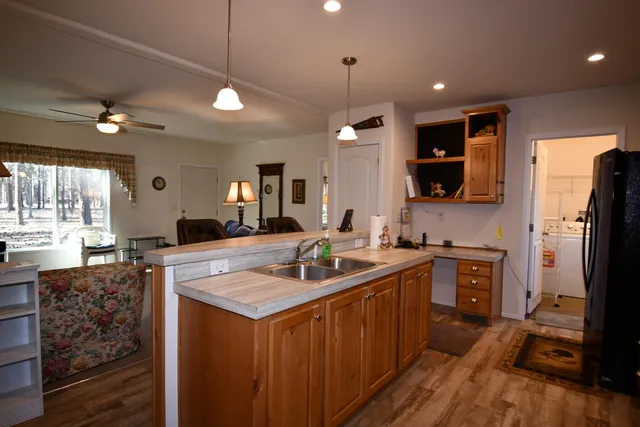 a kitchen with stainless steel appliances granite countertop a sink a stove and a refrigerator