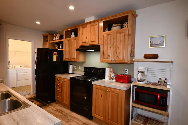 a kitchen with stainless steel appliances granite countertop a refrigerator stove and sink