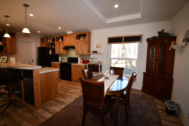 a dining room with furniture a window and stainless steel appliances