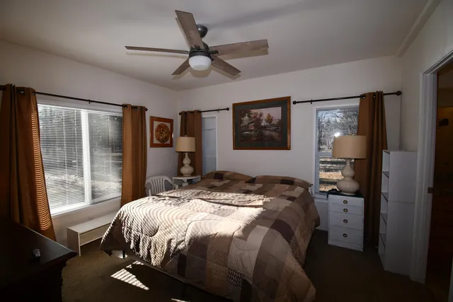 a bed sitting in a bedroom next to a window