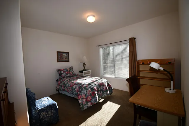 a bedroom with a bed and window