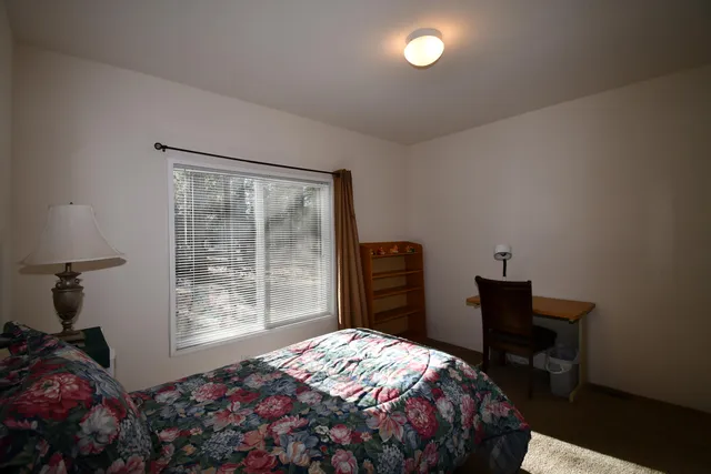 a bedroom with a bed and a window