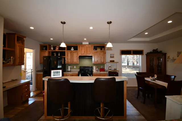 a large kitchen with a table and chairs