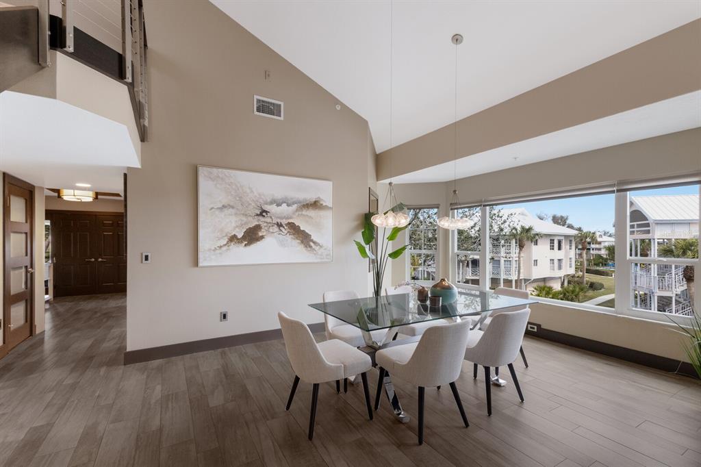 11000 Placida Road, Unit 2203 Placida, FL 33946 - Photo 11 of 64 a view of a dining room with furniture window and wooden floor
