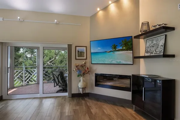 a bedroom with a large bed and a flat tv screen on dresser