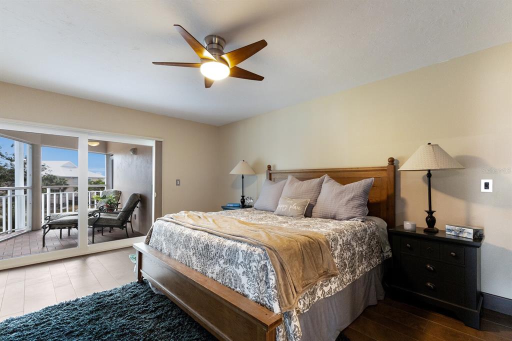 11000 Placida Road, Unit 2203 Placida, FL 33946 - Photo 15 of 64 a bedroom with a bed and wooden floor