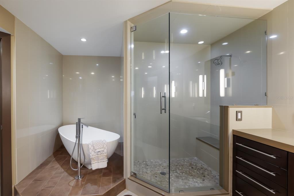 11000 Placida Road, Unit 2203 Placida, FL 33946 - Photo 20 of 64 a bathroom with a mirror a toilet and shower