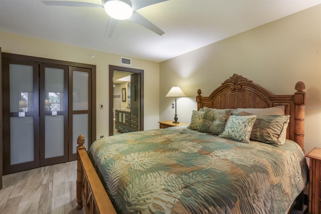 11000 Placida Road, Unit 2203 Placida, FL 33946 - Photo 26 of 64 a bedroom with a bed and a chandelier