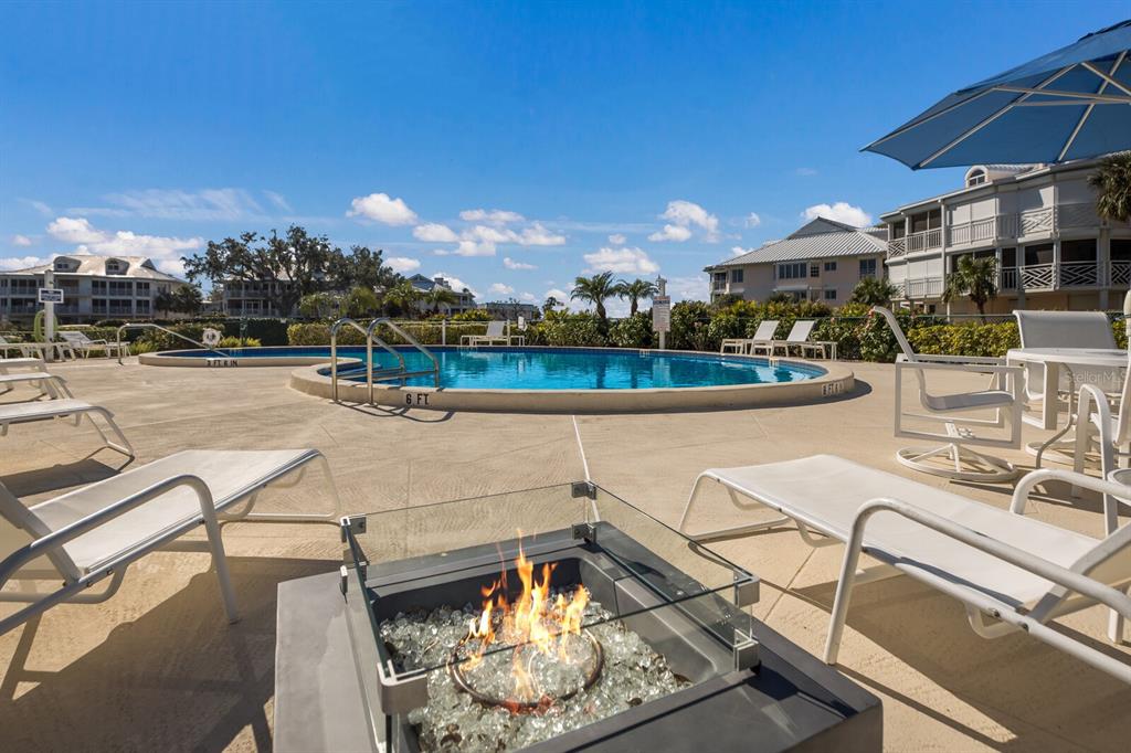 11000 Placida Road, Unit 2203 Placida, FL 33946 - Photo 39 of 64 a view of a swimming pool with lounge chairs