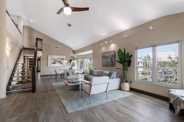 a living room with furniture and a wooden floor