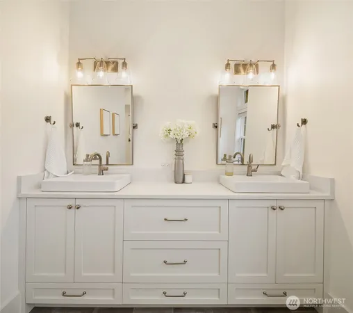 a bathroom with double vanity sink a mirror and vanity