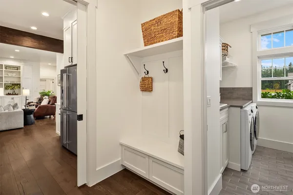 a view of a hallway with bathroom and wooden floor