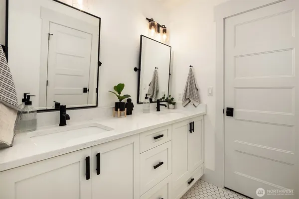 a bathroom with a double vanity sink and a mirror