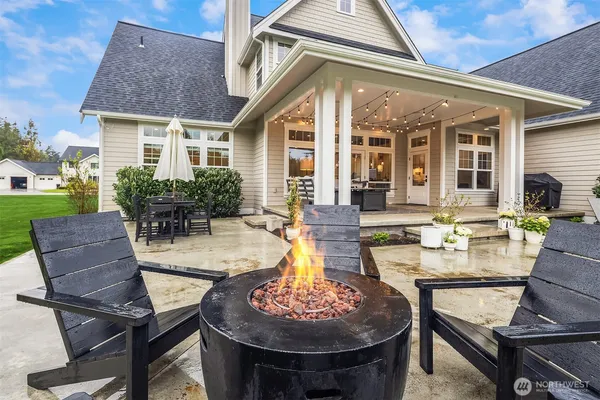 a front view of a house with swimming pool having outdoor seating