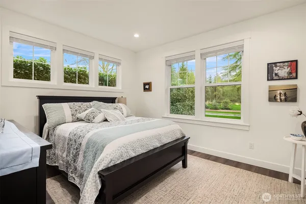 a bedroom with a bed and a large window