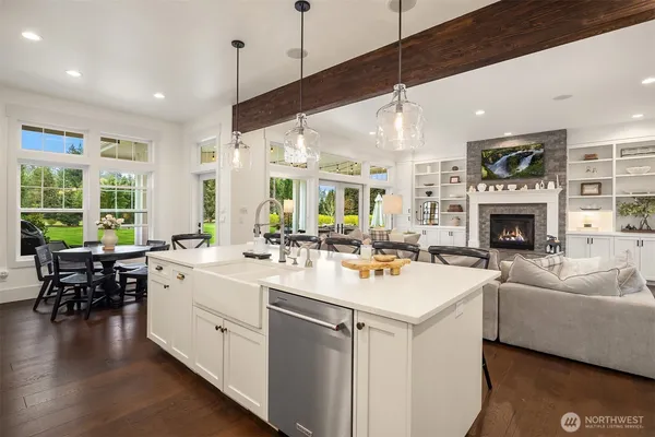 a kitchen with a stove a refrigerator and a fireplace