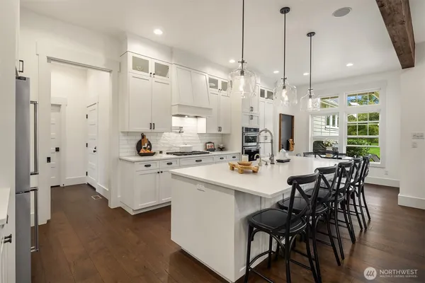 a large kitchen with a table and chairs