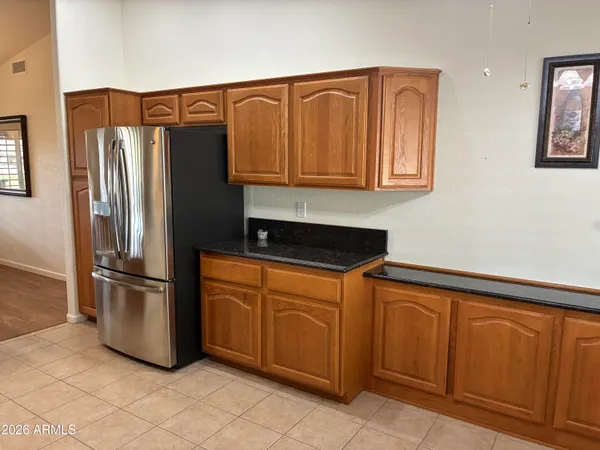 a kitchen with stainless steel appliances granite countertop a refrigerator and a stove top oven