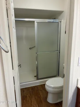 a bathroom with a toilet and a shower