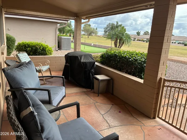 a view of balcony with furniture and garden
