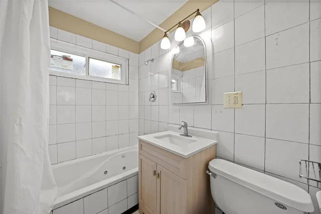 a bathroom with a sink a toilet and bathtub