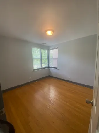 an empty room with a empty space and windows