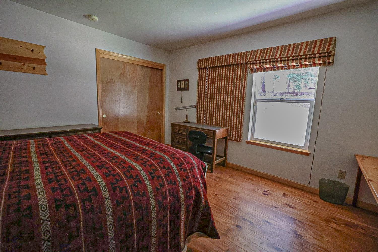 67922 Beasore Road Bass Lake, CA 93604 - Photo 18 of 39 a bedroom with a bed and a window