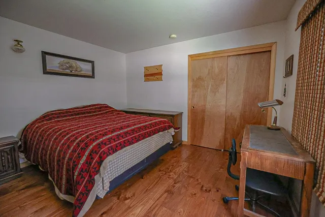 a bedroom with a bed and dresser