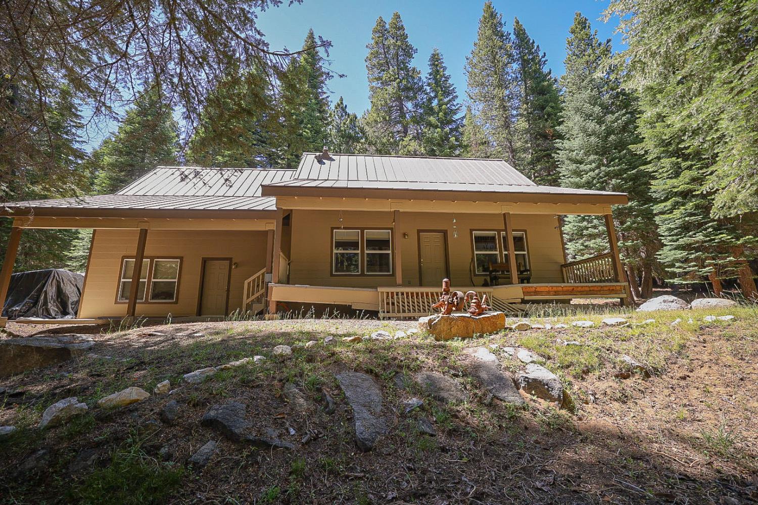 67922 Beasore Road Bass Lake, CA 93604 - Photo 2 of 39 a front view of a house with a garden