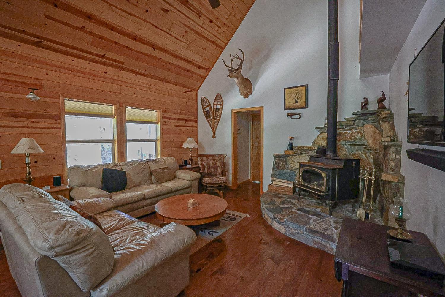 67922 Beasore Road Bass Lake, CA 93604 - Photo 7 of 39 a living room with furniture a fireplace and a flat screen tv