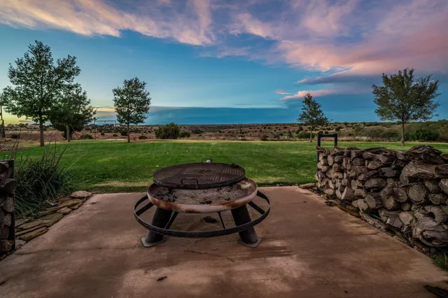 a view of a house with a big yard and potted plants