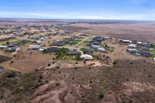 a large kitchen with stainless steel appliances kitchen island granite countertop a sink and cabinets