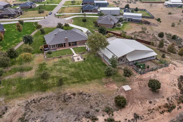a bathroom with a tub shower and mirror