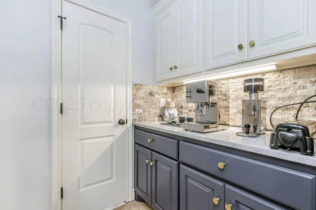 a bathroom with a granite countertop sink a toilet and a mirror