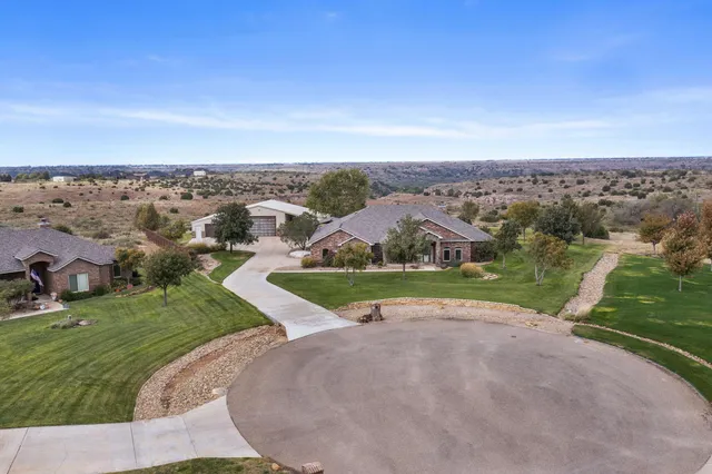 an aerial view of a house with a yard