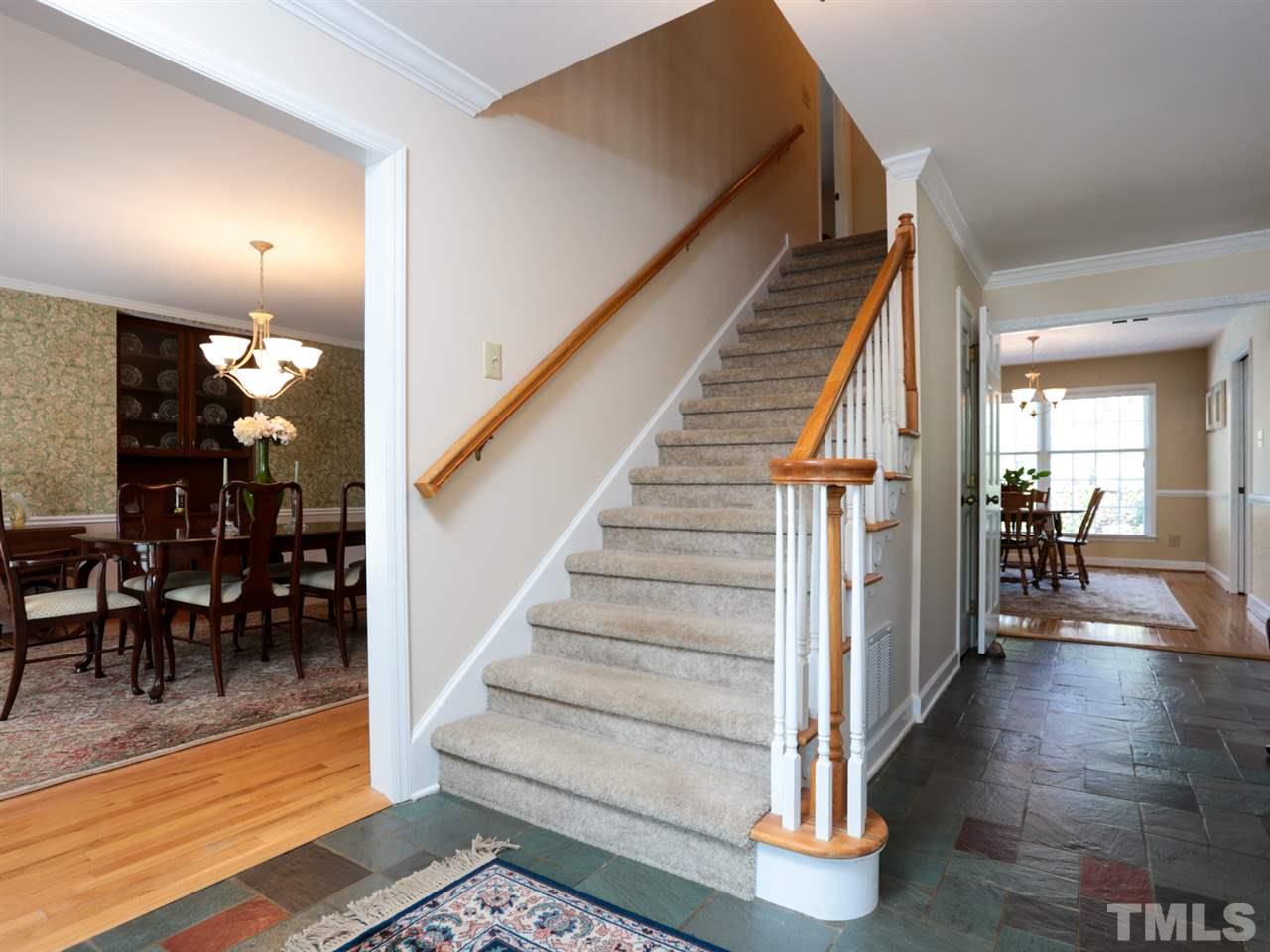 1413 Pony Run Road Raleigh, NC 27615 - Photo 2 of 25 a view of a hallway with wooden floor staircase and a living room
