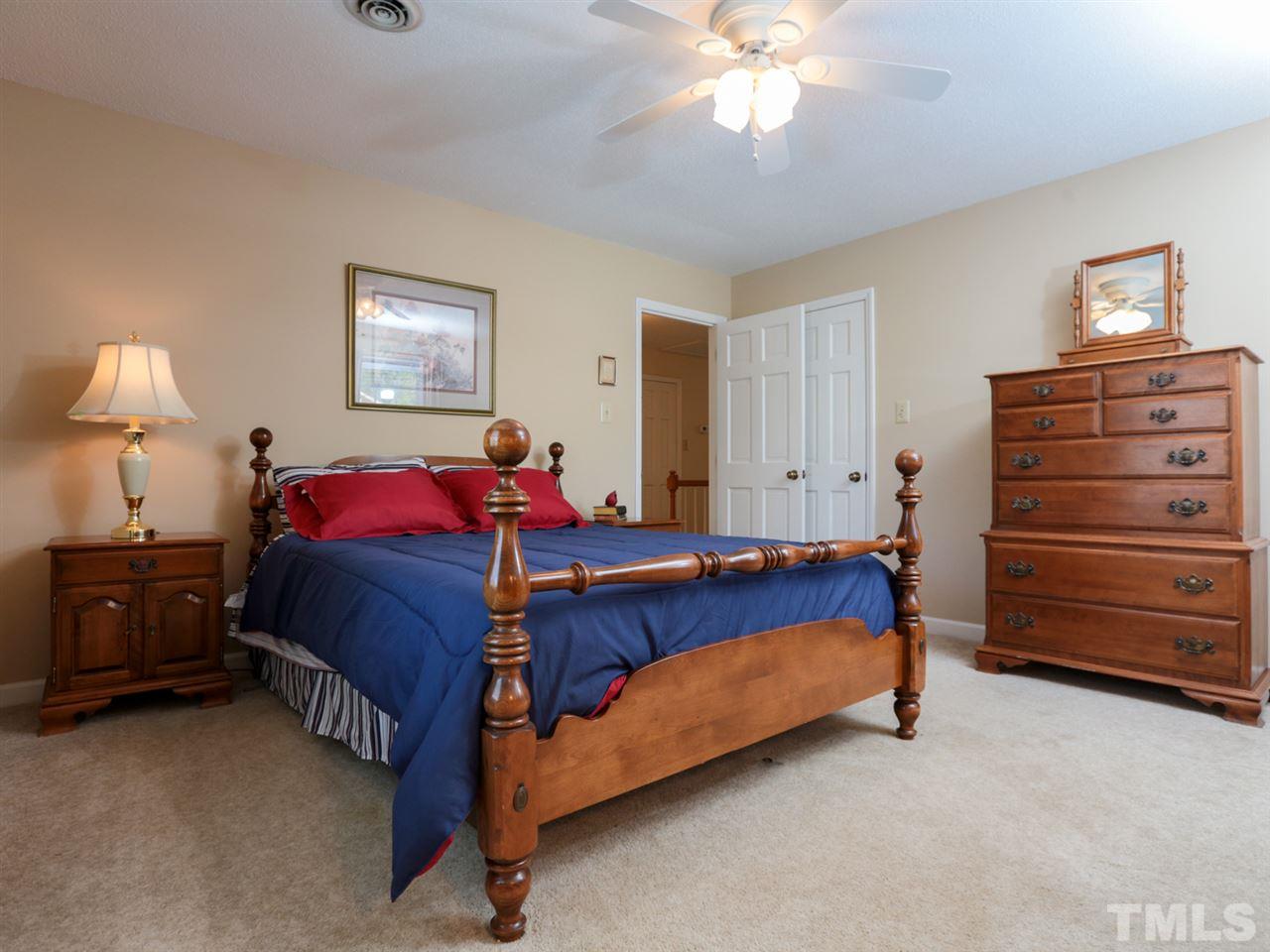 1413 Pony Run Road Raleigh, NC 27615 - Photo 16 of 25 a bed room with a bed and a night stand