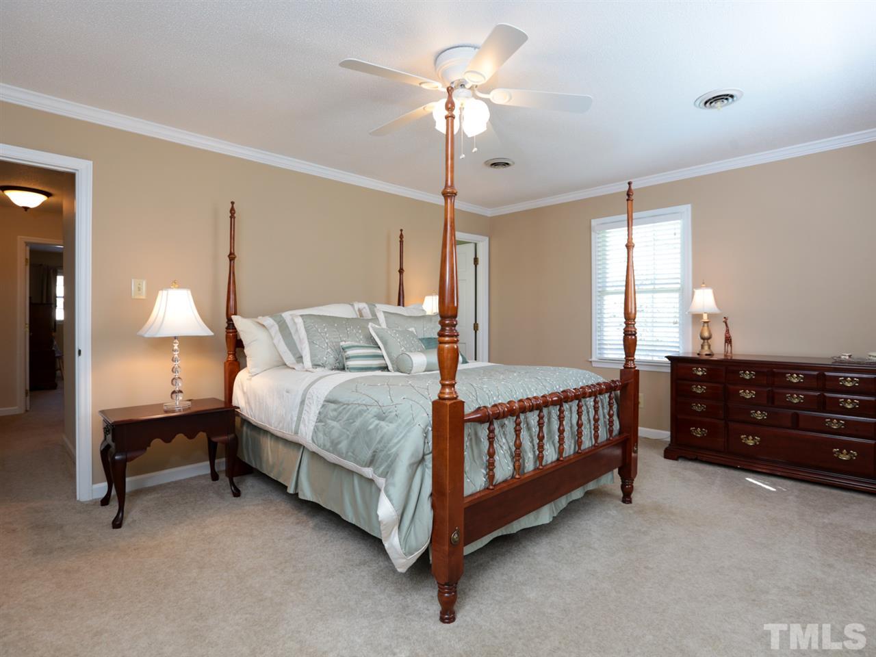 1413 Pony Run Road Raleigh, NC 27615 - Photo 17 of 25 a bed room with a bed and a chandelier