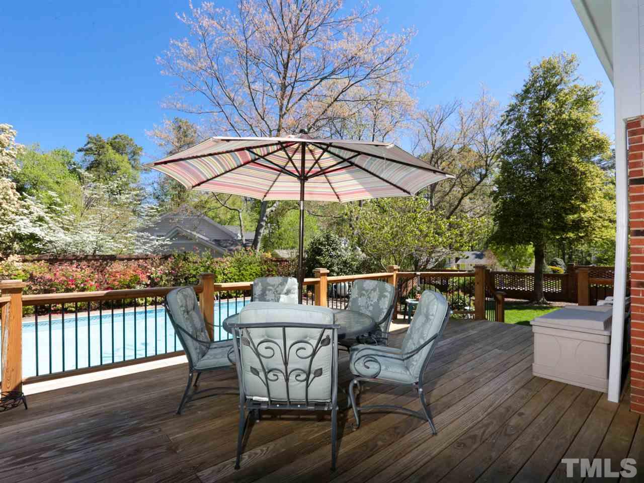 1413 Pony Run Road Raleigh, NC 27615 - Photo 23 of 25 a patio with wooden floor a yard a table and chairs