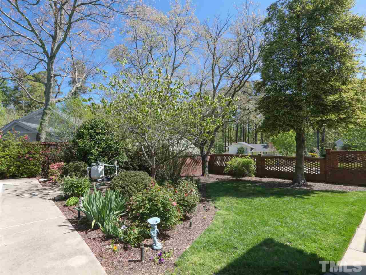 1413 Pony Run Road Raleigh, NC 27615 - Photo 24 of 25 a view of a garden with plants and large trees